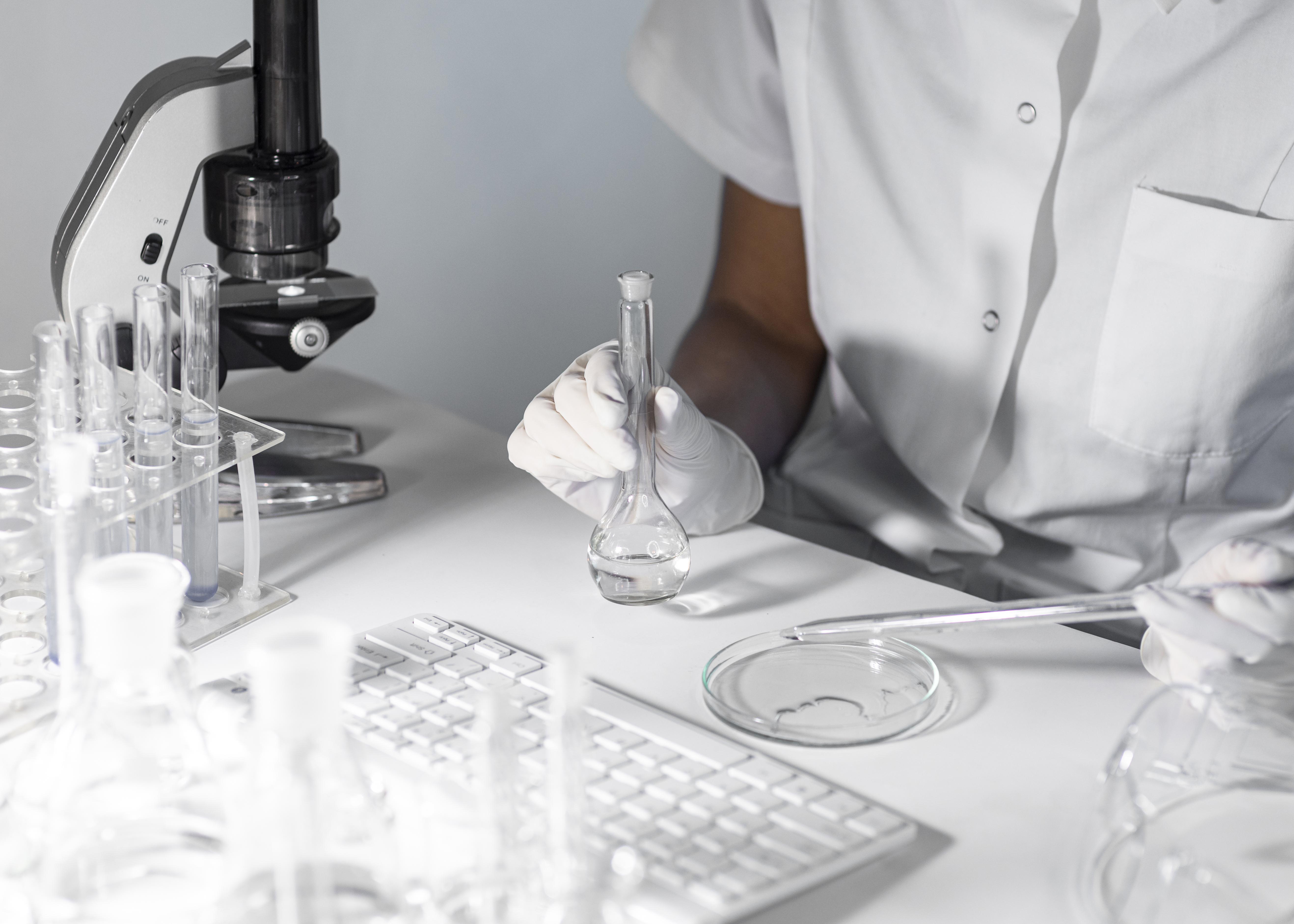 Close Up Scientist Holding Glassware